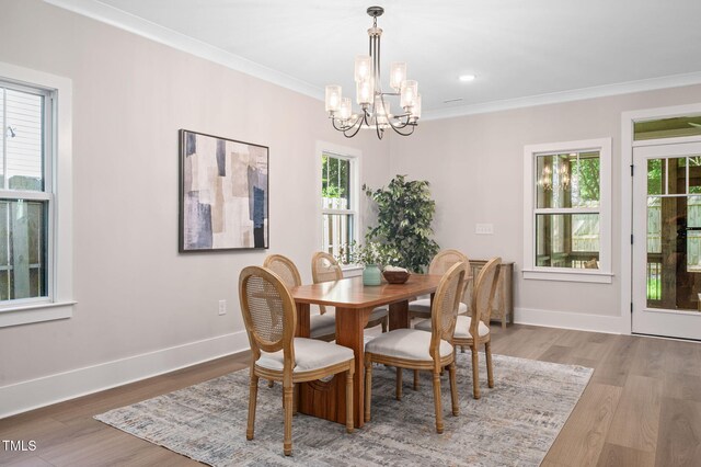 703 E Markham Ave, Durham, NC 27701 - dining area with a chandelier, healthy amount of natural light, wood finished floors, and crown molding