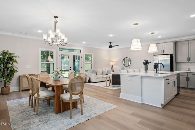703 E Markham Ave, Durham, NC 27701 - dining room featuring recessed lighting, ornamental molding, light wood-type flooring, a ceiling fan, and a chandelier