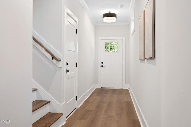 703 E Markham Ave, Durham, NC 27701 - entryway with wood finished floors, stairs, and ornamental molding