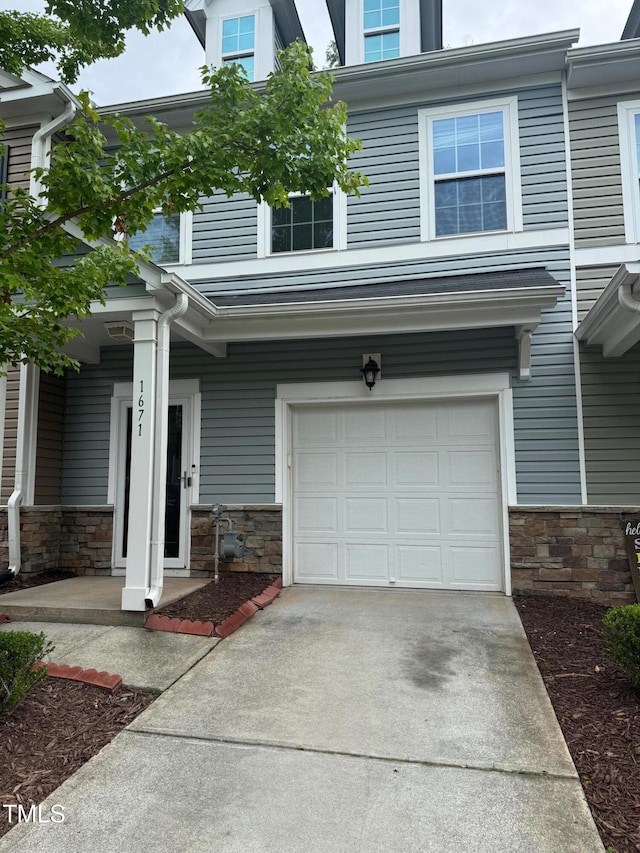 1671 Holly Grove Way, Durham, NC 27713 - view of front facade featuring an attached garage, stone siding, and concrete driveway