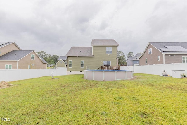 back of property with a residential view and crawl space