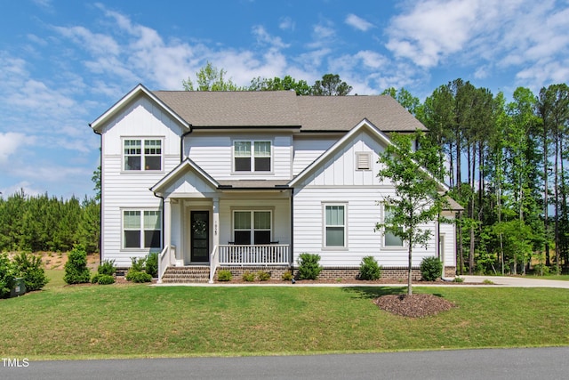 1928 Vandiver Way, Apex, NC 27523 - view of front of home featuring covered porch, board and batten siding, and a front lawn