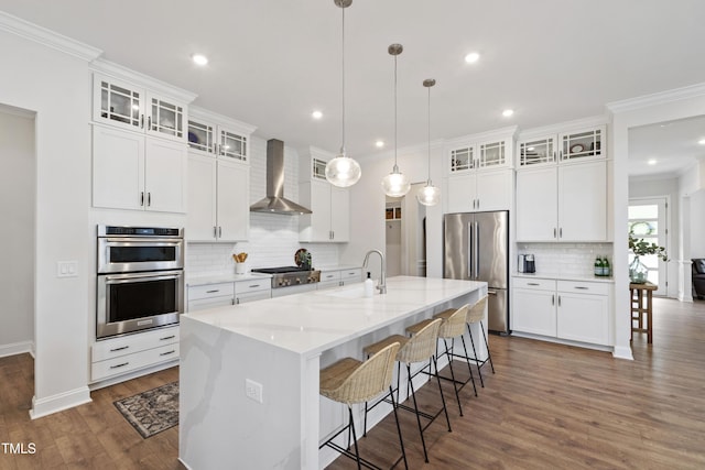 1928 Vandiver Way, Apex, NC 27523 - kitchen with wall chimney range hood, stainless steel appliances, a sink, decorative backsplash, and ornamental molding