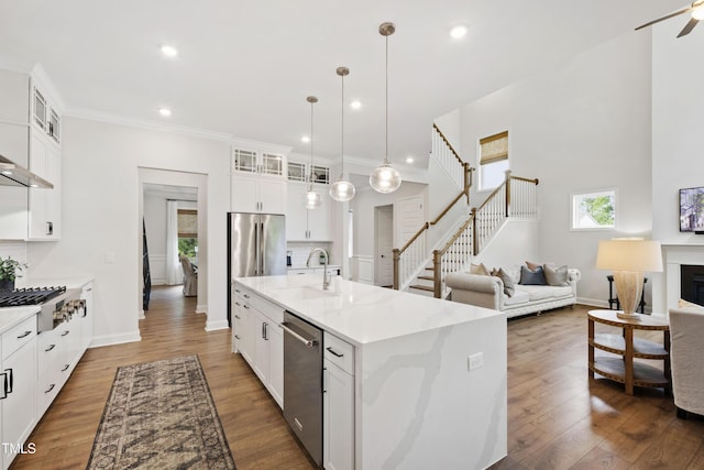 1928 Vandiver Way, Apex, NC 27523 - kitchen featuring stainless steel appliances, a sink, open floor plan, recessed lighting, and white cabinets