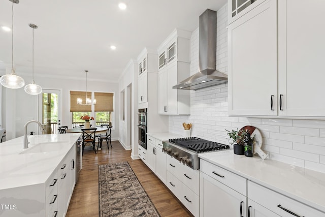1928 Vandiver Way, Apex, NC 27523 - kitchen with wall chimney range hood, appliances with stainless steel finishes, a sink, crown molding, and backsplash