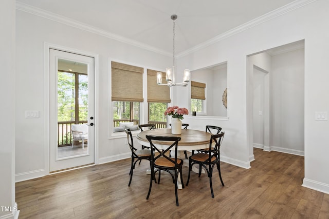1928 Vandiver Way, Apex, NC 27523 - dining room featuring wood finished floors, a chandelier, crown molding, and baseboards