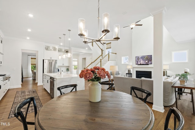 1928 Vandiver Way, Apex, NC 27523 - dining area featuring plenty of natural light, a fireplace, wood finished floors, recessed lighting, and ornamental molding