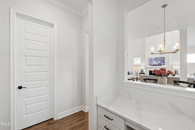 1928 Vandiver Way, Apex, NC 27523 - kitchen with dark wood-style flooring, ornamental molding, white cabinetry, a chandelier, and pendant lighting