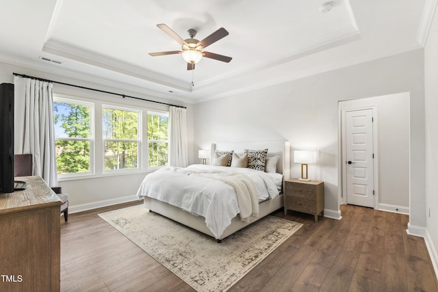 1928 Vandiver Way, Apex, NC 27523 - bedroom featuring a tray ceiling, crown molding, dark wood-style floors, baseboards, and a ceiling fan