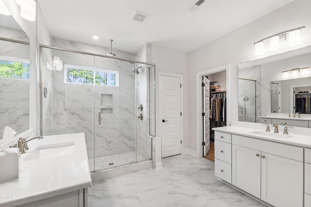 1928 Vandiver Way, Apex, NC 27523 - bathroom with two vanities, a marble finish shower, a walk in closet, marble finish flooring, and baseboards