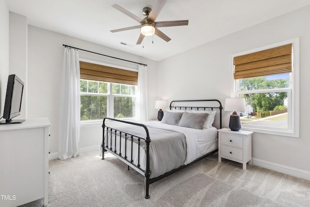 1928 Vandiver Way, Apex, NC 27523 - carpeted bedroom featuring multiple windows, baseboards, and a ceiling fan