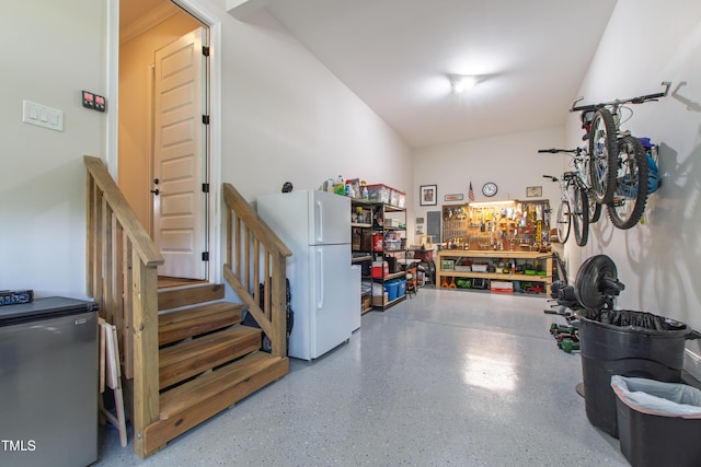 1928 Vandiver Way, Apex, NC 27523 - garage featuring freestanding refrigerator, a workshop area, and fridge