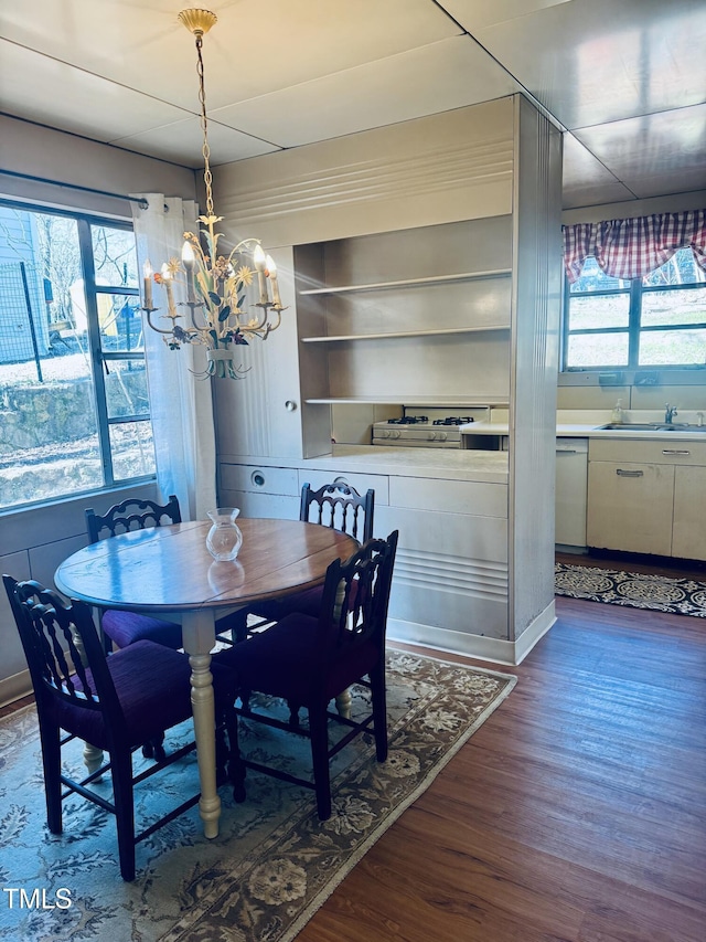 dining room with dark wood-style floors and a chandelier