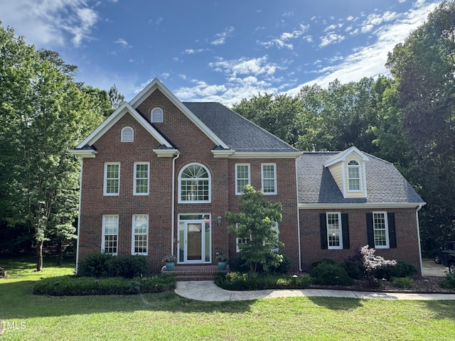 view of front of property with a front yard and brick siding