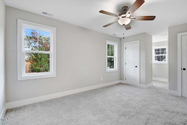 1201 Crawford St S, Wilson, NC 27893 - unfurnished bedroom featuring carpet floors, multiple windows, and a ceiling fan