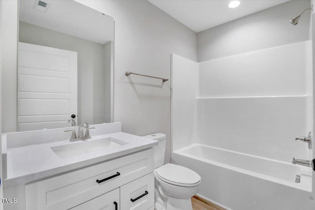 1201 Crawford St S, Wilson, NC 27893 - bathroom with vanity, washtub / shower combination, recessed lighting, and wood finished floors