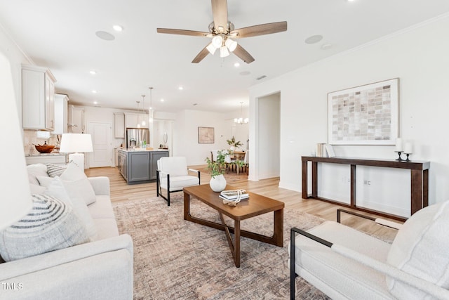 1625 Plover Cir, Fuquay Varina, NC 27526 - living room featuring light wood-style floors, recessed lighting, ceiling fan, and ornamental molding