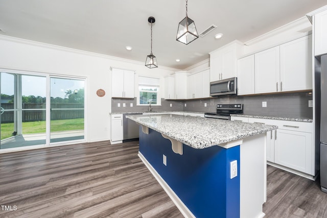 171 Piney Field Rd, Fuquay Varina, NC 27526 - kitchen with appliances with stainless steel finishes, a sink, a kitchen island, crown molding, and dark wood-style floors