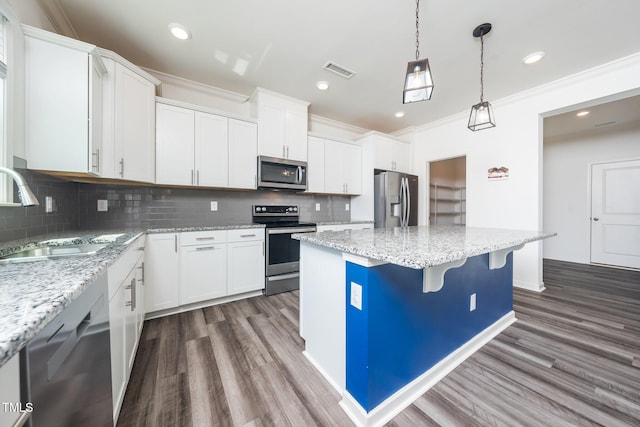 171 Piney Field Rd, Fuquay Varina, NC 27526 - kitchen with stainless steel appliances, a sink, a kitchen island, dark wood finished floors, and crown molding