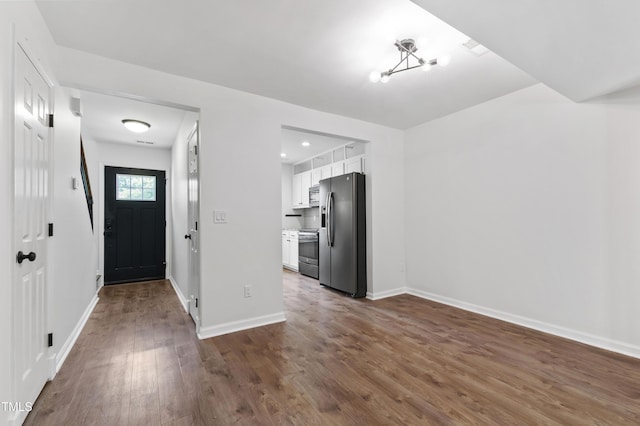 129 Assembly Ct, Cary, NC 27511 - foyer featuring dark wood-style flooring and baseboards