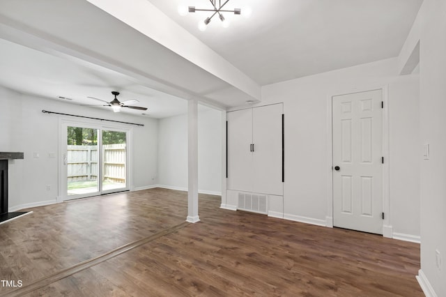 129 Assembly Ct, Cary, NC 27511 - unfurnished living room with wood finished floors, baseboards, ceiling fan, a chandelier, and a fireplace with raised hearth