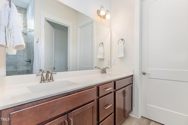 bathroom with double vanity and a shower