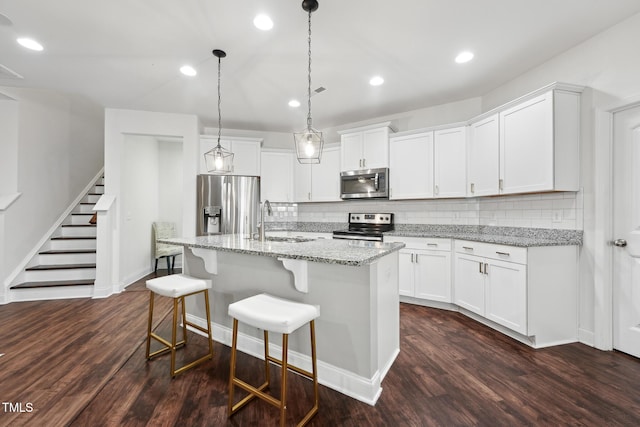 475 Long View Dr, Franklinton, NC 27525 - kitchen with appliances with stainless steel finishes, a sink, decorative backsplash, dark wood-type flooring, and recessed lighting