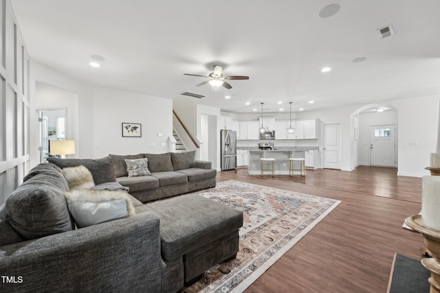 475 Long View Dr, Franklinton, NC 27525 - living area with ceiling fan, arched walkways, recessed lighting, dark wood-style flooring, and stairs