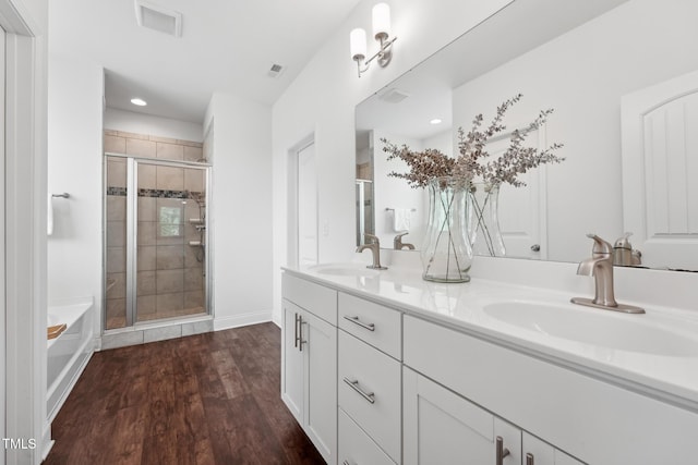 475 Long View Dr, Franklinton, NC 27525 - full bathroom with a bath, double vanity, a stall shower, wood finished floors, and recessed lighting