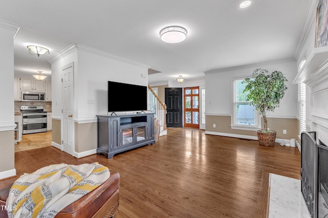 2721 Dahlgreen Rd, Raleigh, NC 27615 - living room with a fireplace with flush hearth, light wood finished floors, stairway, baseboards, and ornamental molding