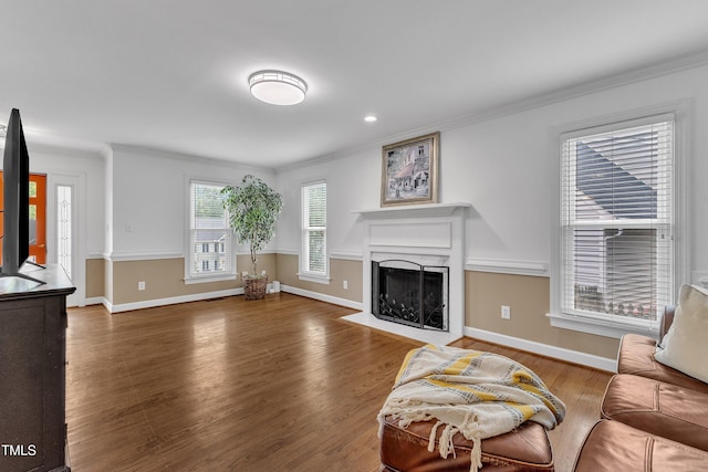 2721 Dahlgreen Rd, Raleigh, NC 27615 - living room featuring a fireplace with flush hearth, wood finished floors, crown molding, and baseboards