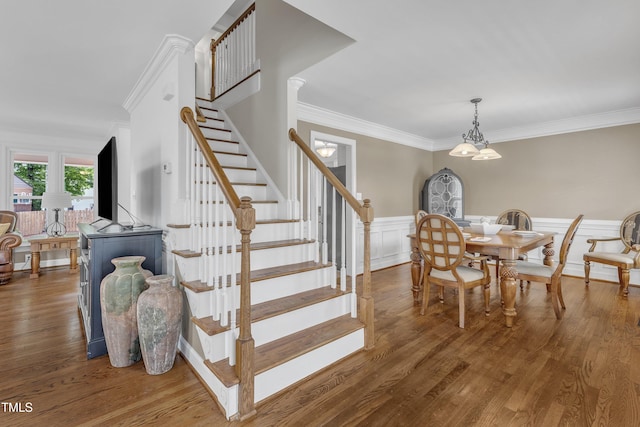 2721 Dahlgreen Rd, Raleigh, NC 27615 - dining room featuring ornamental molding, stairway, wood finished floors, a wainscoted wall, and a decorative wall
