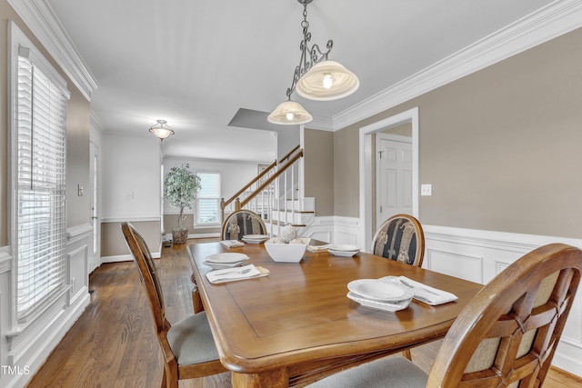 2721 Dahlgreen Rd, Raleigh, NC 27615 - dining area featuring stairs, wood finished floors, ornamental molding, a wainscoted wall, and a decorative wall