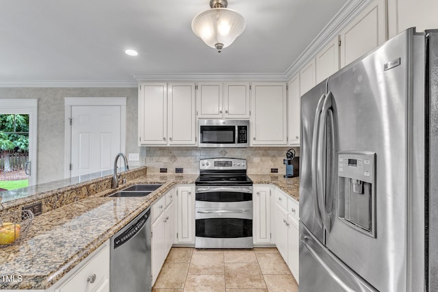 2721 Dahlgreen Rd, Raleigh, NC 27615 - kitchen featuring appliances with stainless steel finishes, a sink, white cabinetry, ornamental molding, and light stone counters