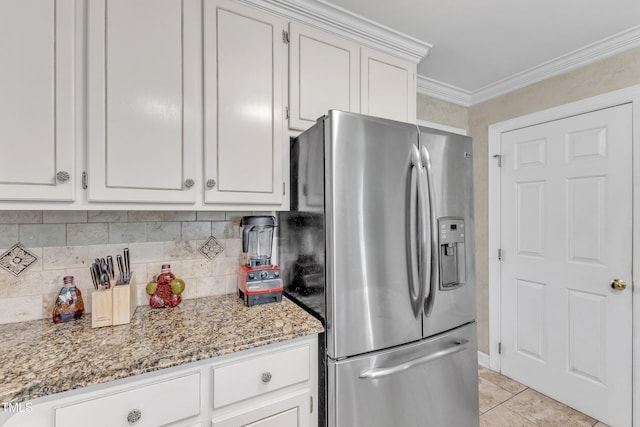2721 Dahlgreen Rd, Raleigh, NC 27615 - kitchen featuring stainless steel fridge with ice dispenser, light stone counters, white cabinetry, ornamental molding, and light tile patterned floors