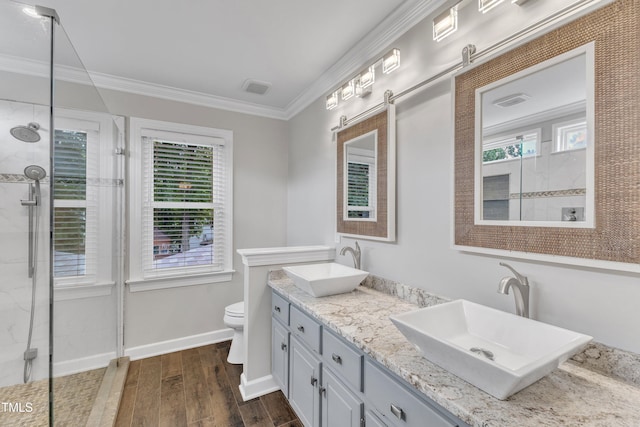 2721 Dahlgreen Rd, Raleigh, NC 27615 - bathroom featuring toilet, wood finished floors, a tile shower, healthy amount of natural light, and crown molding