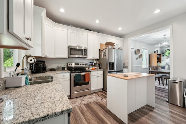 2620 Holloway St, Durham, NC 27703 - kitchen featuring stainless steel appliances, a sink, dark wood-type flooring, white cabinets, and recessed lighting