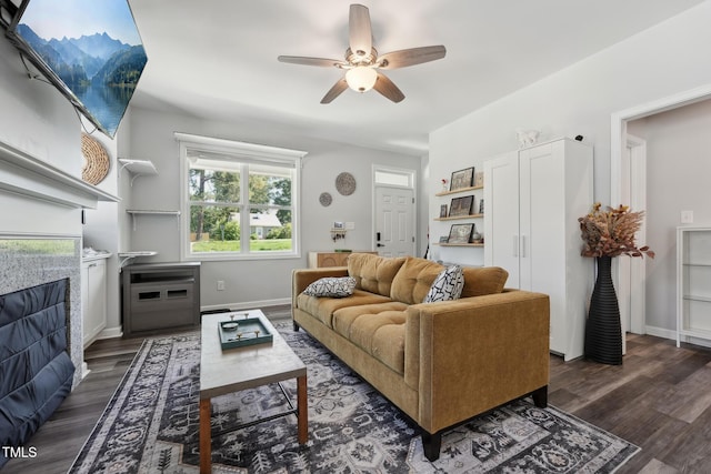 2620 Holloway St, Durham, NC 27703 - living area featuring dark wood finished floors, a ceiling fan, and baseboards