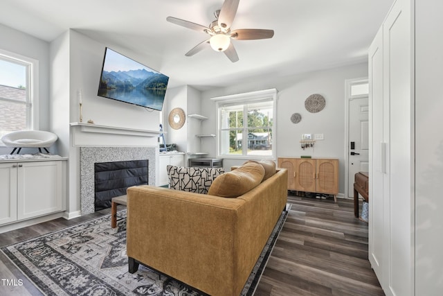 2620 Holloway St, Durham, NC 27703 - living area with dark wood-style flooring, a tile fireplace, and a ceiling fan
