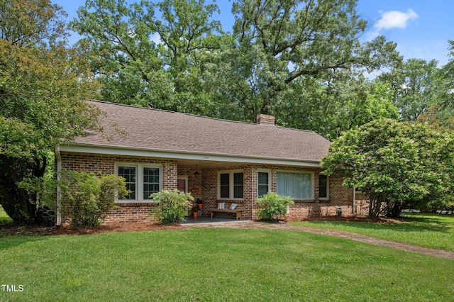 1605 Longview Ave, Tarboro, NC 27886 - ranch-style house with brick siding, a front yard, a chimney, roof with shingles, and a patio