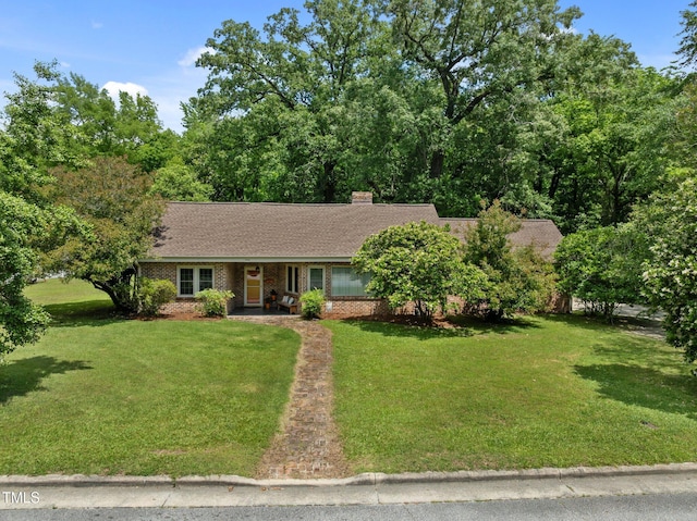 1605 Longview Ave, Tarboro, NC 27886 - view of front facade featuring a front yard, brick siding, a porch, a chimney, and roof with shingles