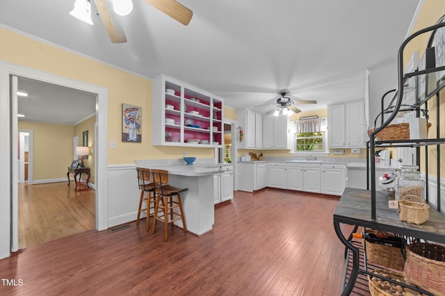 1605 Longview Ave, Tarboro, NC 27886 - kitchen with a ceiling fan, white cabinets, light countertops, a peninsula, and wood finished floors