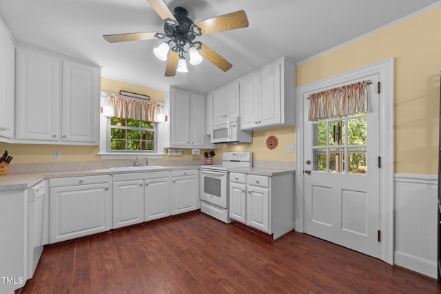1605 Longview Ave, Tarboro, NC 27886 - kitchen featuring white appliances, white cabinets, a sink, wainscoting, and ornamental molding