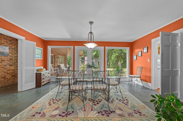 1605 Longview Ave, Tarboro, NC 27886 - dining area featuring baseboards, crown molding, and brick wall