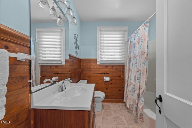 1605 Longview Ave, Tarboro, NC 27886 - full bath featuring wooden walls, toilet, a wainscoted wall, vanity, and shower / tub combo