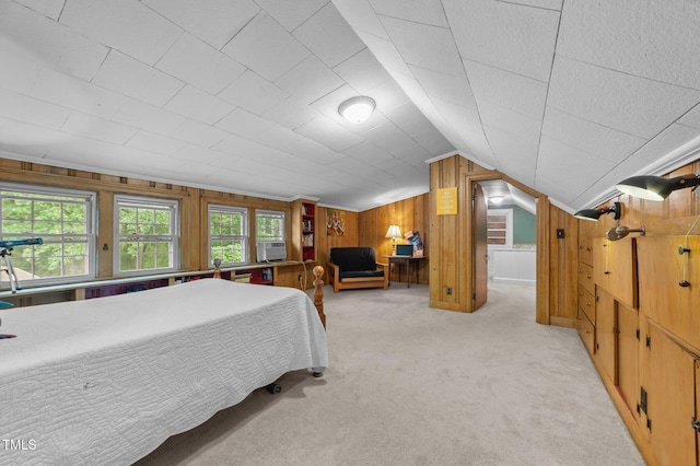 1605 Longview Ave, Tarboro, NC 27886 - bedroom with wooden walls, light colored carpet, vaulted ceiling, and cooling unit