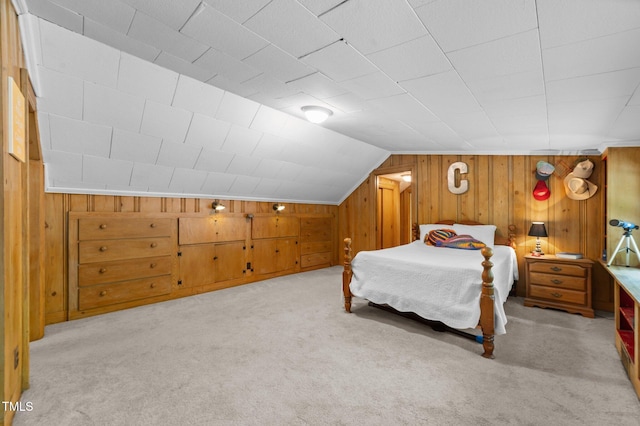 1605 Longview Ave, Tarboro, NC 27886 - bedroom featuring wood walls, vaulted ceiling, and carpet flooring