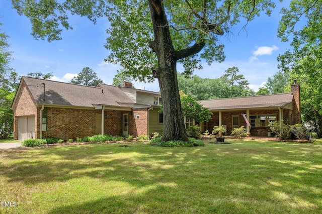 1605 Longview Ave, Tarboro, NC 27886 - view of front of house featuring a chimney, brick siding, a front yard, an attached garage, and a shingled roof