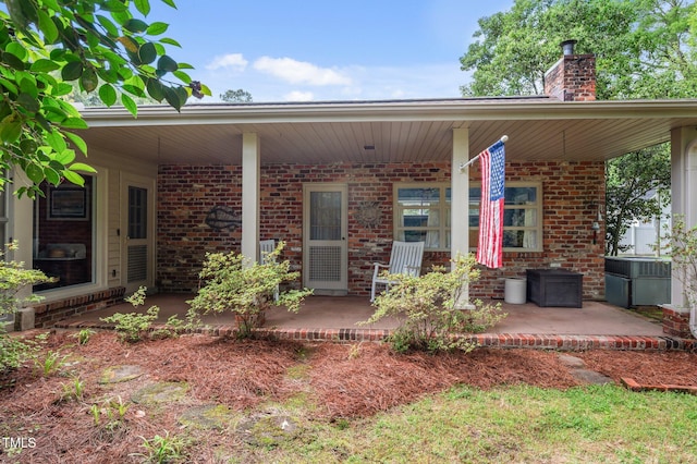 1605 Longview Ave, Tarboro, NC 27886 - rear view of house with brick siding, a chimney, and a patio