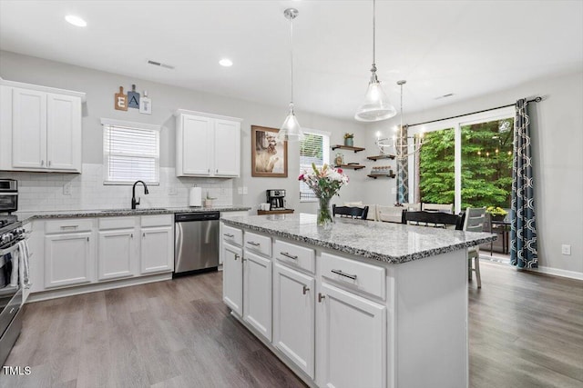 320 Everly Mist Way, Wake Forest, NC 27587 - kitchen with stainless steel dishwasher, a sink, healthy amount of natural light, a center island, and recessed lighting